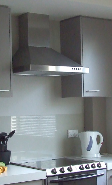 Stainless-steel exhaust hood in a real professional kitchen environment