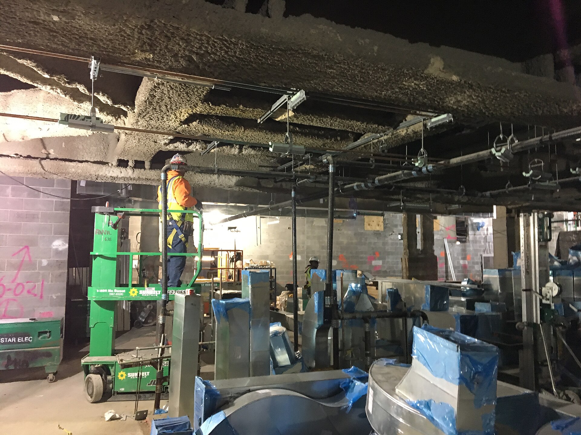 Real overhead HVAC ductwork installed in a commercial building concourse